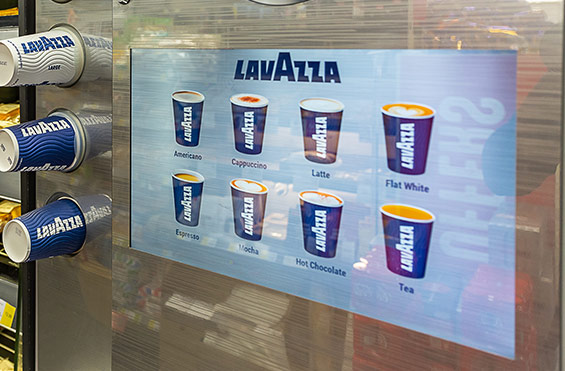 Media display coffee vending machine in a retail environment